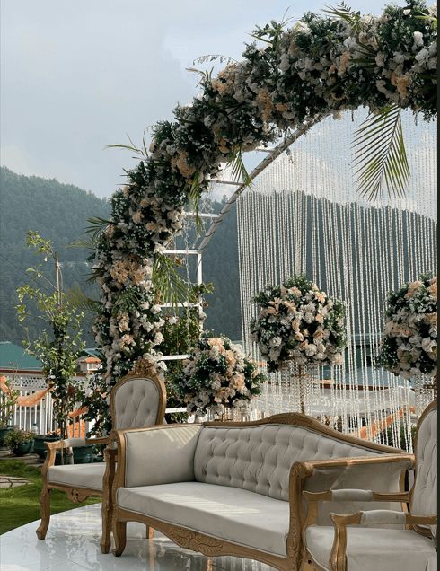 Tufted gold sofa and floral arch on the nikah stage